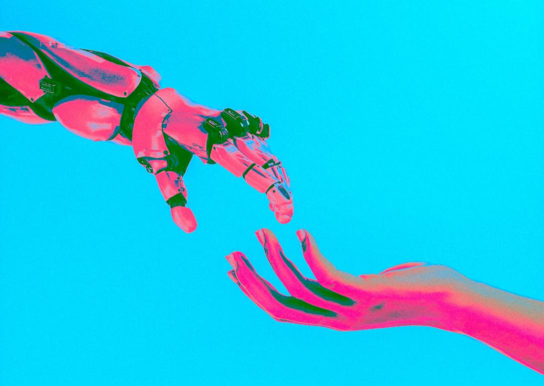 Robot and human hands touching.